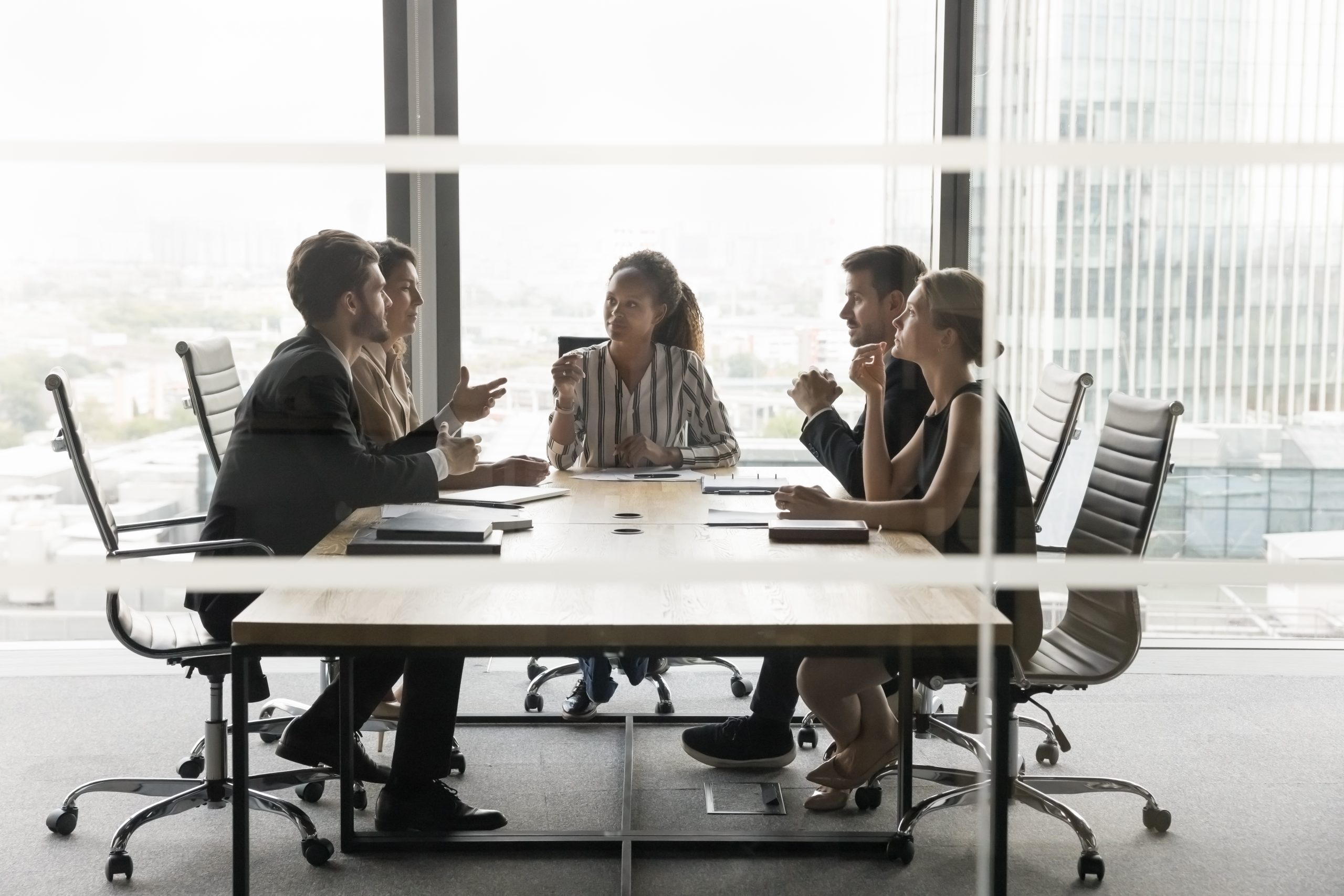 African American business leader woman holding meeting in modern office; leaders